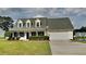 Charming single-Gathering home with a well-manicured lawn, mature trees, and attached two-car garage at 64 Dogwood Rdg, Hampton, GA 30228