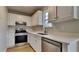 Well-equipped kitchen with stainless steel appliances, updated cabinets, and ample counter space at 64 Dogwood Rdg, Hampton, GA 30228