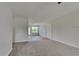 Spacious living area with new carpet, neutral walls, and natural light at 64 Dogwood Rdg, Hampton, GA 30228