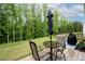 Relaxing backyard featuring a well-manicured lawn, a patio area with outdoor furniture and a wooded perimeter at 109 Aspen Way, Dallas, GA 30157