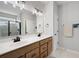 Bathroom with double sink vanity, white countertop, wood cabinets, and a large mirror with a view to the shower at 109 Aspen Way, Dallas, GA 30157