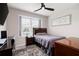 Cozy bedroom featuring a bed, nightstand, and dresser, complemented by a ceiling fan and natural light from the window at 109 Aspen Way, Dallas, GA 30157