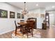 A dining area with hardwood floors, a round wooden table, a chandelier, and elegant wall decor at 109 Aspen Way, Dallas, GA 30157