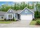 Inviting home exterior with a well-manicured lawn, colorful flowerbeds and a two-car garage at 109 Aspen Way, Dallas, GA 30157