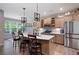 Well-lit kitchen featuring an island with barstool seating, stainless steel appliances, and pendant lighting at 109 Aspen Way, Dallas, GA 30157