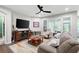 Bright living room featuring hardwood floors, large windows, comfortable furniture, and a ceiling fan at 109 Aspen Way, Dallas, GA 30157