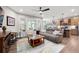 Open-concept living room featuring hardwood floors, large windows, a ceiling fan, and comfortable furniture at 109 Aspen Way, Dallas, GA 30157