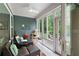Cozy sunroom with comfortable seating, a cat tree, view of the backyard and access to the outside at 109 Aspen Way, Dallas, GA 30157
