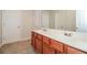 Well-lit bathroom with double vanity, ample cabinet space, tile floor, and bright countertop, creating an organized space at 194 Wilhelmina Dr, Austell, GA 30168