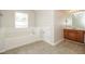 Bright bathroom featuring a bathtub, vanity with sink, and tile flooring at 194 Wilhelmina Dr, Austell, GA 30168