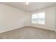 Bright bedroom featuring neutral walls, plush carpeting, a large window with blinds, and ample natural light creating a cozy space at 194 Wilhelmina Dr, Austell, GA 30168
