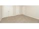 A neutral-toned bedroom featuring carpet flooring and bright white doors at 194 Wilhelmina Dr, Austell, GA 30168