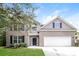 Charming two-story home with a brick and vinyl exterior, lush lawn, and a two-car garage, creating a welcoming curb appeal at 194 Wilhelmina Dr, Austell, GA 30168