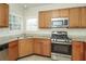 Updated kitchen featuring granite counters, stainless appliances, and wood cabinets at 194 Wilhelmina Dr, Austell, GA 30168