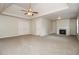 Large living room featuring a fireplace, carpeted floor, a ceiling fan and a tray ceiling at 194 Wilhelmina Dr, Austell, GA 30168