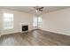 Bright living room with wood floors, fireplace, and large windows at 194 Wilhelmina Dr, Austell, GA 30168