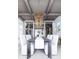 Features an elegant dining area with wood ceiling, custom chandelier, wine storage, and seating for eight at 250 Mayfield Rd, Alpharetta, GA 30009