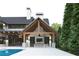 An impressive patio with a large TV area and a ceiling fan overlooks the pool at 250 Mayfield Rd, Alpharetta, GA 30009