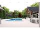 A modern pool is the centerpiece of the backyard's outdoor kitchen and bar area at 250 Mayfield Rd, Alpharetta, GA 30009