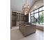 Spacious walk-in closet with custom shelving, chandelier and center island with glass top at 250 Mayfield Rd, Alpharetta, GA 30009