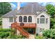 Back exterior of home features deck, staircase, large windows and manicured lawn at 3348 Perrington Pointe, Marietta, GA 30066