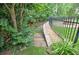 Beautifully landscaped backyard features stone steps and a black metal fence at 3348 Perrington Pointe, Marietta, GA 30066