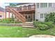 Landscaped backyard features a raised deck with stairs, a stone patio, and lush greenery at 3348 Perrington Pointe, Marietta, GA 30066