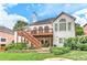 Exterior view of back of the house featuring a multi-level deck, stone patio, and lush landscaping at 3348 Perrington Pointe, Marietta, GA 30066