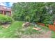 Large backyard features a sloped lawn, stone terracing, and mature trees at 3348 Perrington Pointe, Marietta, GA 30066