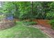Fenced backyard features a retaining wall and a wooden gate at 3348 Perrington Pointe, Marietta, GA 30066