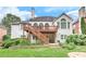 Backyard with multi-level deck, stairs to a stone patio, and lush landscaping under mature trees at 3348 Perrington Pointe, Marietta, GA 30066