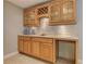 Bar area featuring wood cabinetry, sink, counter seating and wine rack at 3348 Perrington Pointe, Marietta, GA 30066