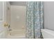 Bathroom with tiled shower and bathtub with curtain, toilet, and white-painted walls at 3348 Perrington Pointe, Marietta, GA 30066