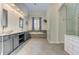 Bathroom with dual sinks, a soaking tub, white tile shower and herringbone floors at 3348 Perrington Pointe, Marietta, GA 30066