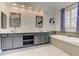 Bright bathroom featuring dual sinks and a soaking tub with tile surround at 3348 Perrington Pointe, Marietta, GA 30066