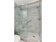 Walk-in shower features gray marble-look tile, glass door, rain shower head, and a built-in seat at 3348 Perrington Pointe, Marietta, GA 30066