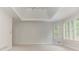 Bright bedroom featuring plantation shutters and a tray ceiling with ceiling fan at 3348 Perrington Pointe, Marietta, GA 30066