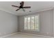 Spacious bedroom with neutral walls, ceiling fan, crown moulding, and a window with plantation shutters at 3348 Perrington Pointe, Marietta, GA 30066