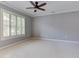 Spacious bedroom with neutral walls, ceiling fan, crown moulding, and a window with plantation shutters at 3348 Perrington Pointe, Marietta, GA 30066