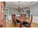 Bright dining room featuring hardwood floors, a chandelier, and traditional wainscoting at 3348 Perrington Pointe, Marietta, GA 30066