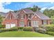 Charming brick home with a well-manicured lawn and lush landscaping in a suburban neighborhood at 3348 Perrington Pointe, Marietta, GA 30066