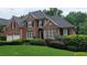 Charming two-story red brick home with black shutters and pristine landscaping at 3348 Perrington Pointe, Marietta, GA 30066