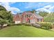 Beautiful brick home with lush landscaping, black shutters, and a two-car garage at 3348 Perrington Pointe, Marietta, GA 30066