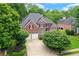Charming two-story brick home featuring an attached two-car garage, manicured lawn, and mature trees at 3348 Perrington Pointe, Marietta, GA 30066