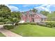 Beautiful two-story brick home featuring a lush green lawn and mature trees at 3348 Perrington Pointe, Marietta, GA 30066