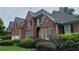 Beautiful red brick home with manicured lawn and elegant architectural details at 3348 Perrington Pointe, Marietta, GA 30066