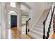 Entry foyer with hardwood floors, staircase, and dark blue front door with arched window at 3348 Perrington Pointe, Marietta, GA 30066