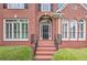 Home featuring a brick facade, arched entryway, and neat landscaping at 3348 Perrington Pointe, Marietta, GA 30066