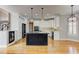 Bright kitchen with white cabinets, a dark island, stainless appliances, and hardwood floors at 3348 Perrington Pointe, Marietta, GA 30066