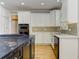 Updated kitchen with stainless steel appliances, custom white cabinetry, and a tile backsplash at 3348 Perrington Pointe, Marietta, GA 30066
